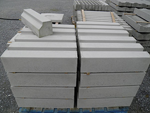 Wide selection of kerbing, including the popular kerb block shown here in plain concrete.